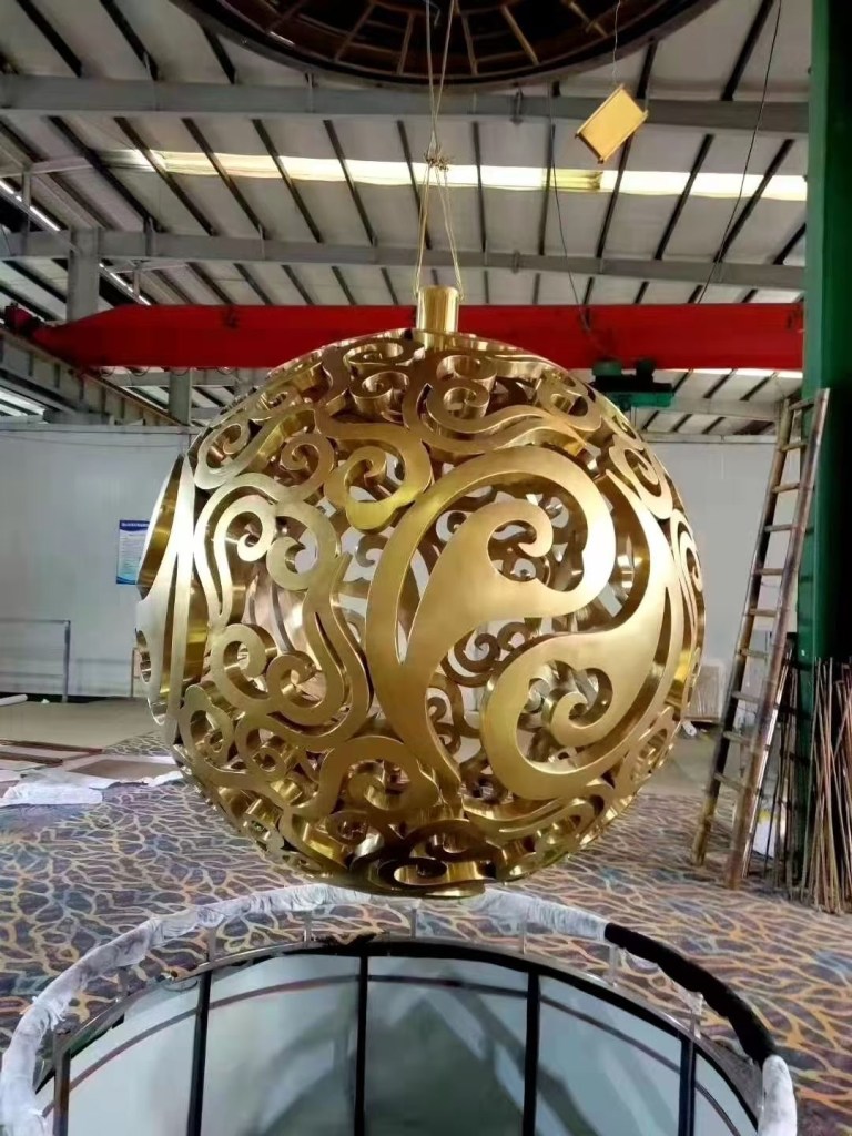 Custom fabricated stainless steel decorative sphere with laser-cut patterns for architectural and project-specific metalwork.