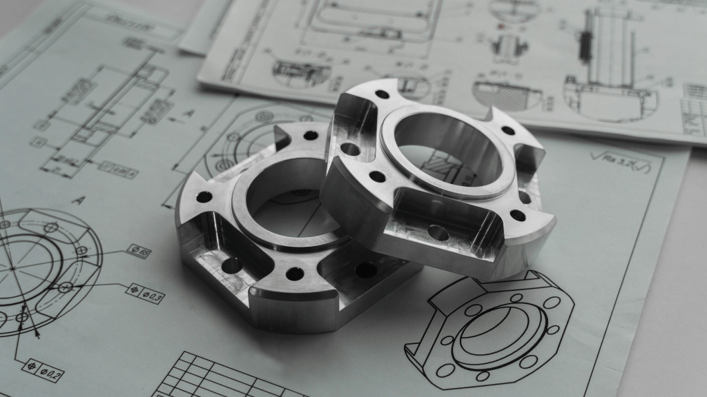 Stainless steel components on technical drawings for custom fabrication and project specification planning.