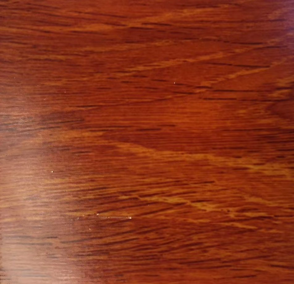 Red copper stainless steel sheet with fine horizontal wood-grain texture in warm reddish brown and copper tones for decorative architectural and interior surface applications.