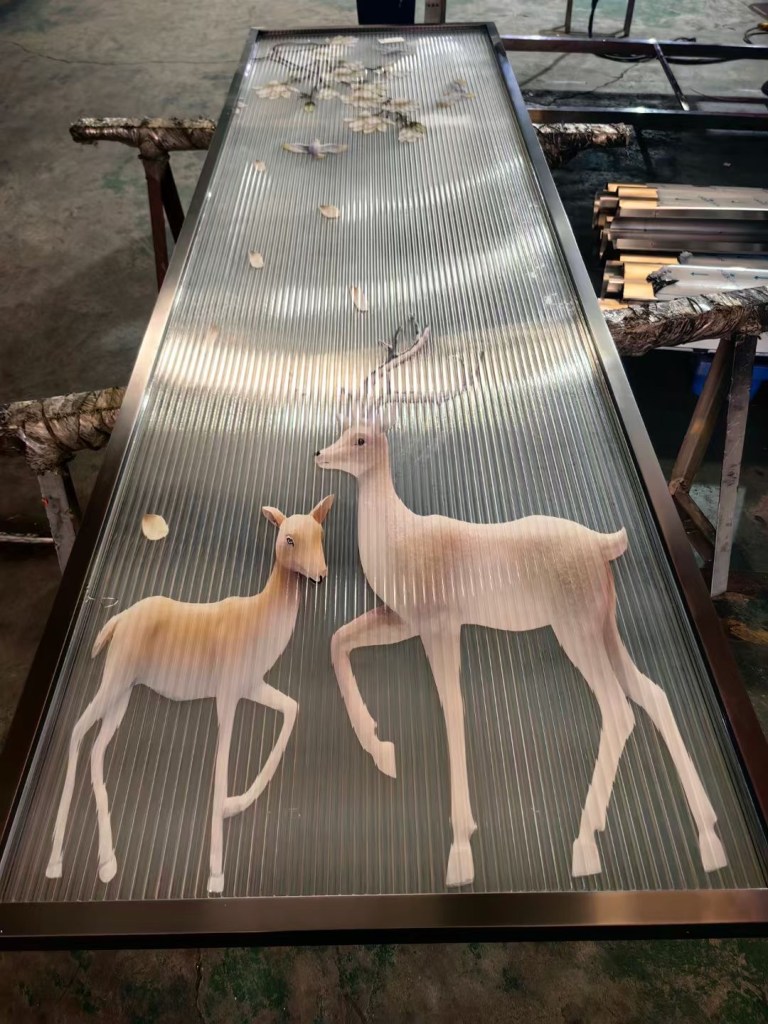 Custom fabricated stainless steel panel featuring two deer and botanical decorative details, produced for architectural interiors, feature walls and decorative metal applications.