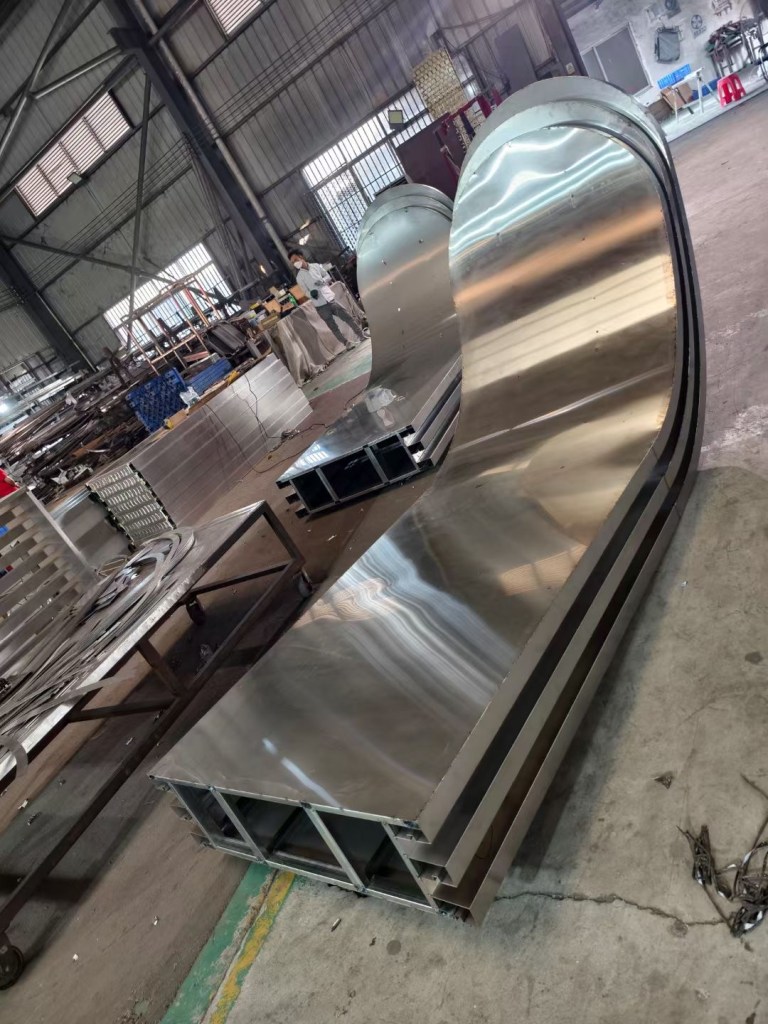 Stainless steel sheet being processed in the workshop for custom fabrication, including cutting, bending and forming for project-specific metal components.