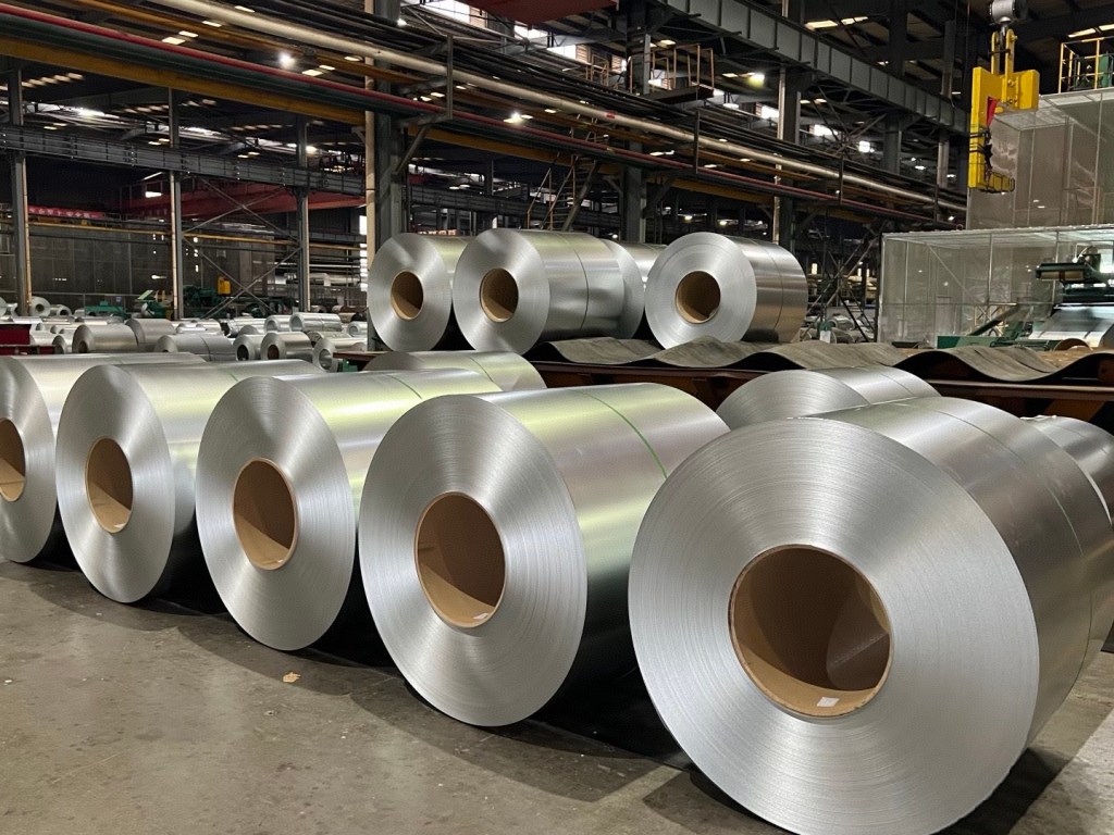 Stainless steel coils stored in an industrial warehouse, supplied as coil material for fabrication, processing and manufacturing applications.