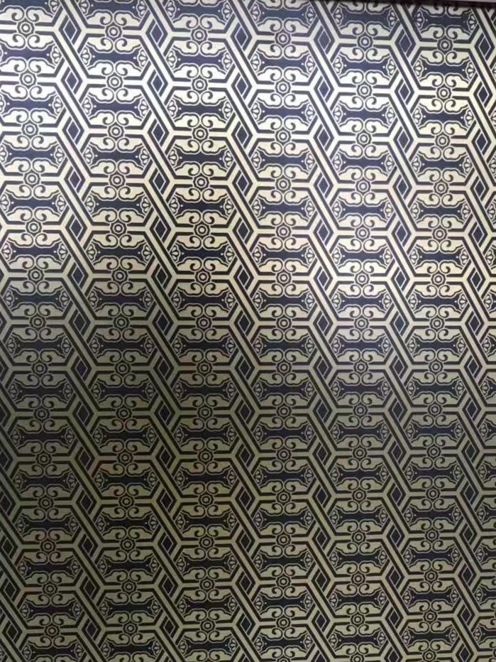 Dark antique copper stainless steel sheet with a repeating geometric lattice and interlocking ornamental pattern for decorative architectural panels and custom metal surfaces.
