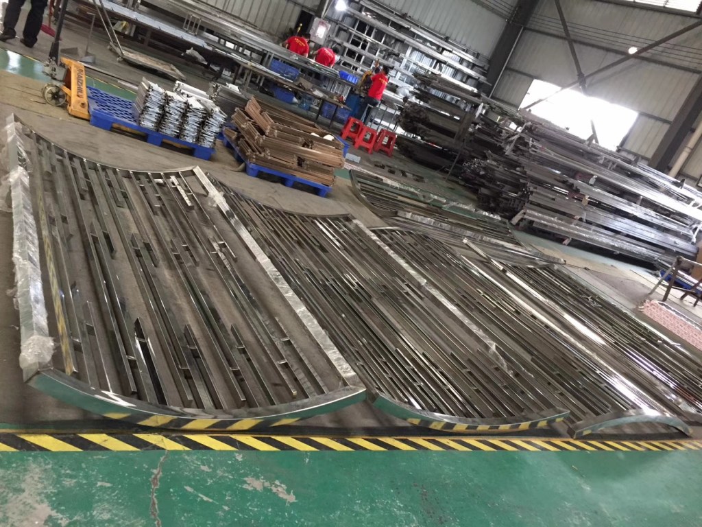 Custom fabricated stainless steel components arranged in a production workshop, manufactured to project-specific drawings, dimensions and specifications for architectural and industrial applications.