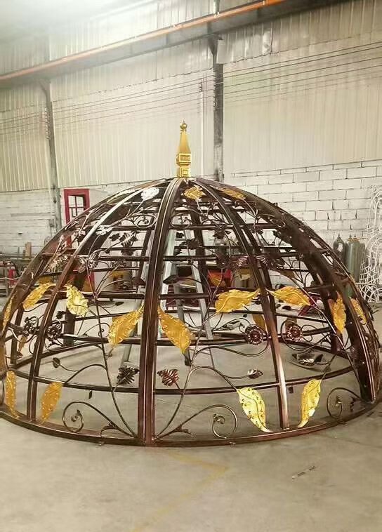 Complex custom metal fabrication of a dome-shaped framework with curved and decorative components, formed, welded and assembled for architectural and decorative applications.