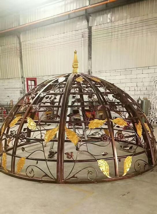 Custom fabricated stainless steel dome-shaped architectural framework with curved metal sections, assembled for decorative and architectural applications.